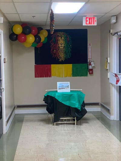 Decorative entrance area with balloons and a tapestry
