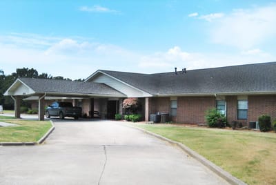 Front exterior view of the facility with a parking area