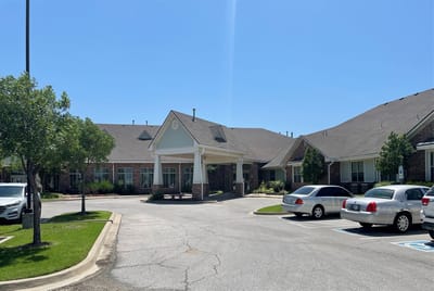 Exterior view of Baptist Village of Oklahoma City with parking lot