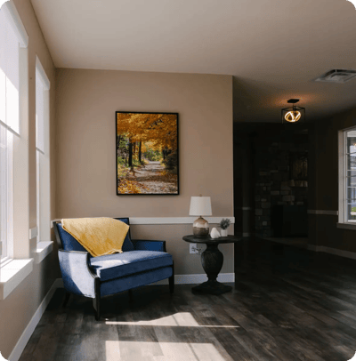 Cozy interior living space with a blue chair and art