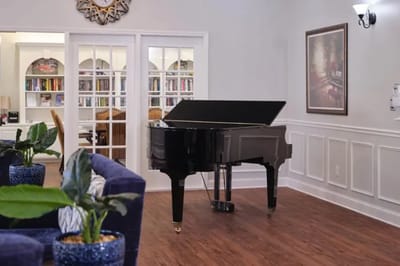 Interior view of a common area with a grand piano