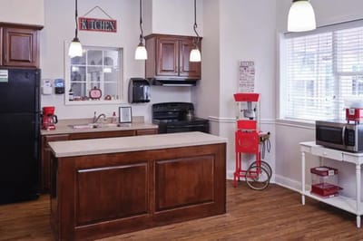 Bright kitchen area with cabinets and appliances