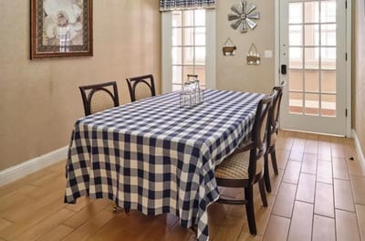 Dining area with checkered tablecloth and chairs