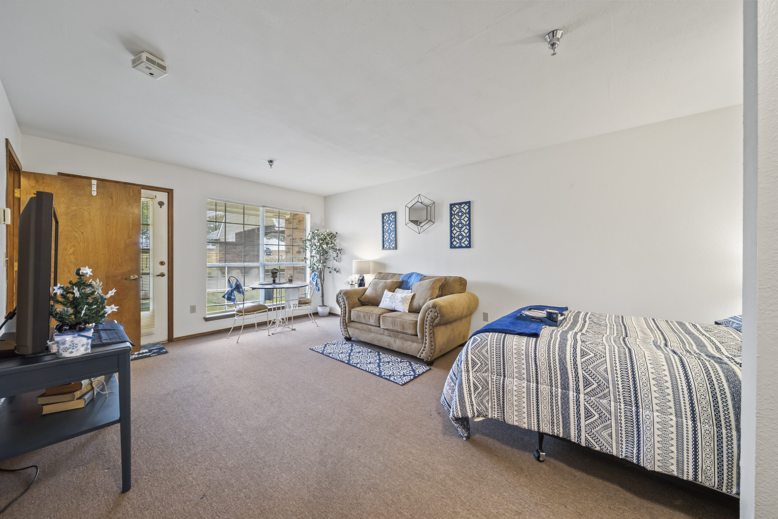 Cozy resident room with a bed and seating area