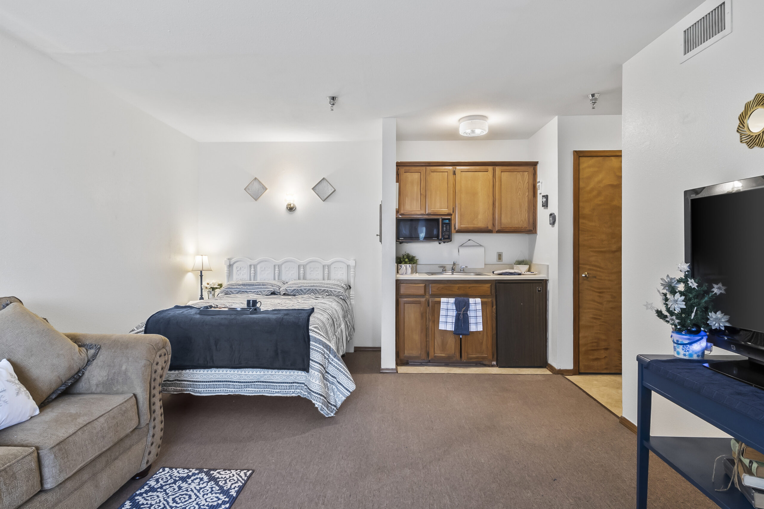 Cozy resident room with kitchen area and seating