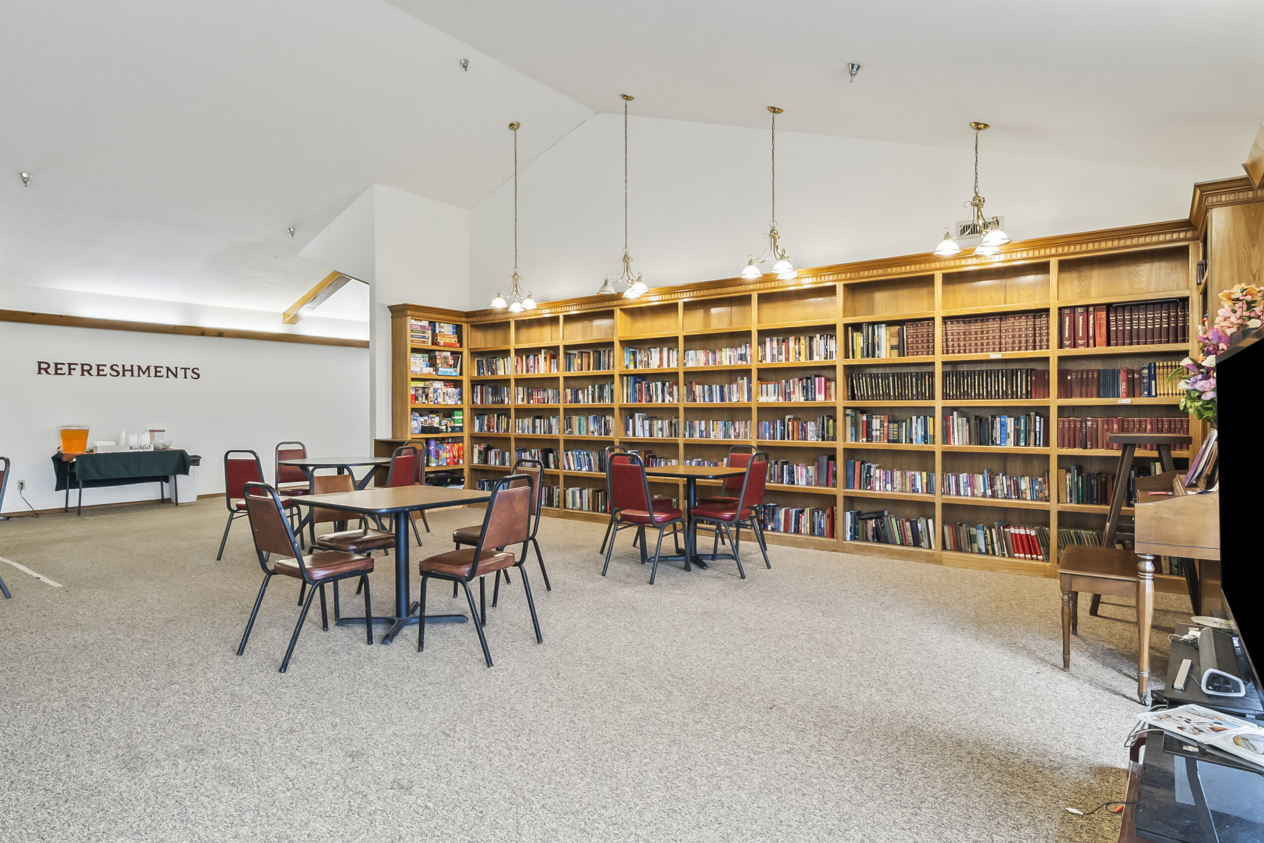 Common area with bookshelf and tables