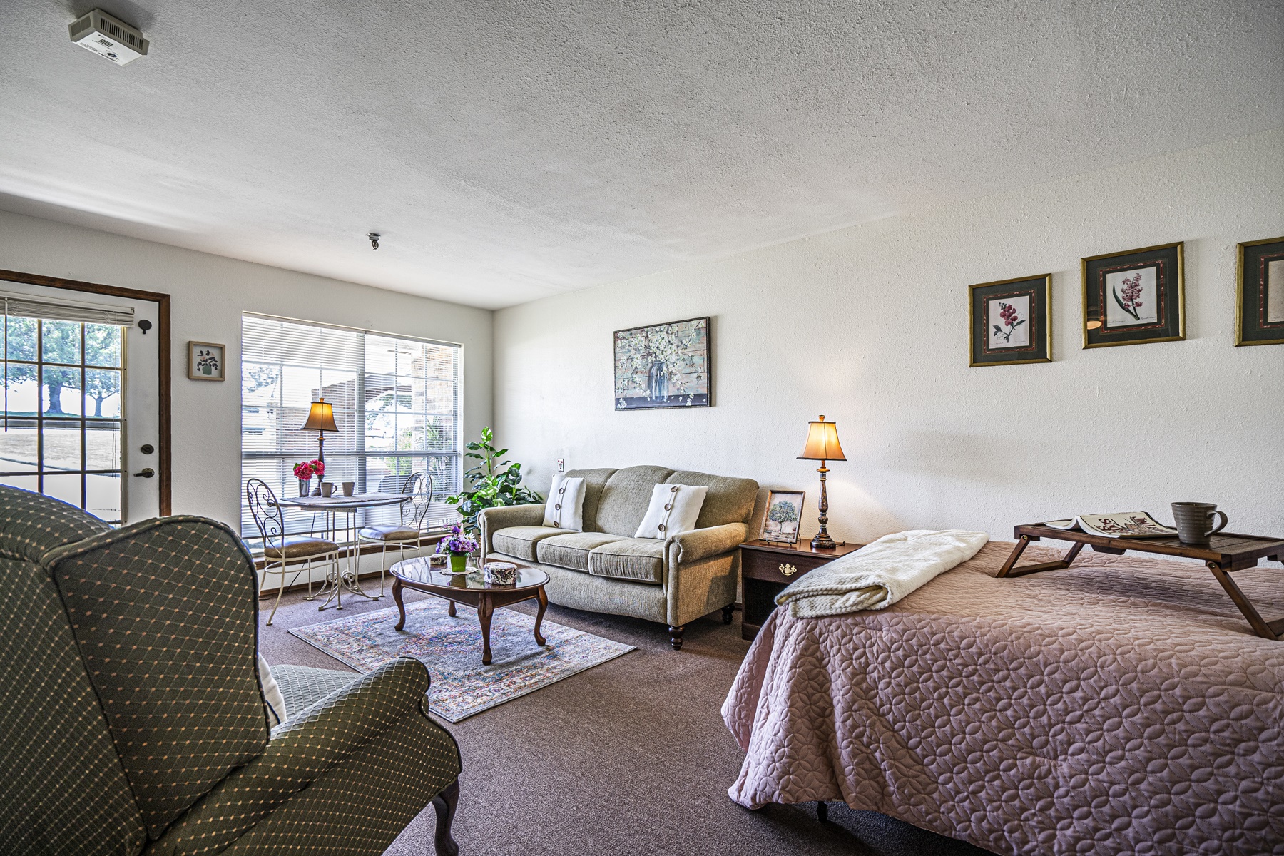 Cozy resident room with living area and bed
