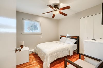 Private resident bedroom with bed and fan