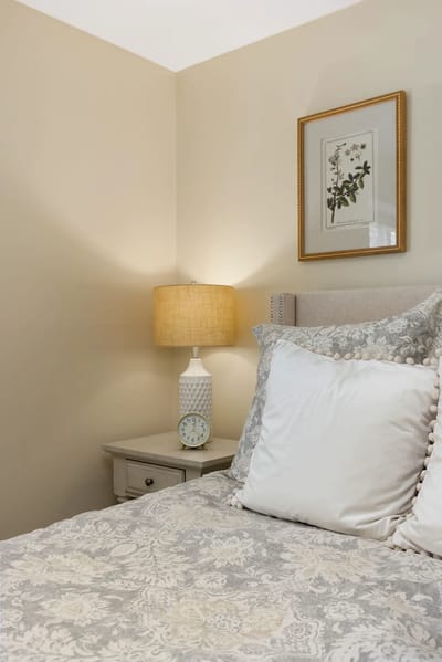 Cozy bedroom with decorative bedding and lamp