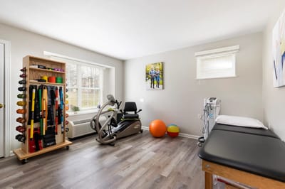 Therapy room with exercise equipment and weights