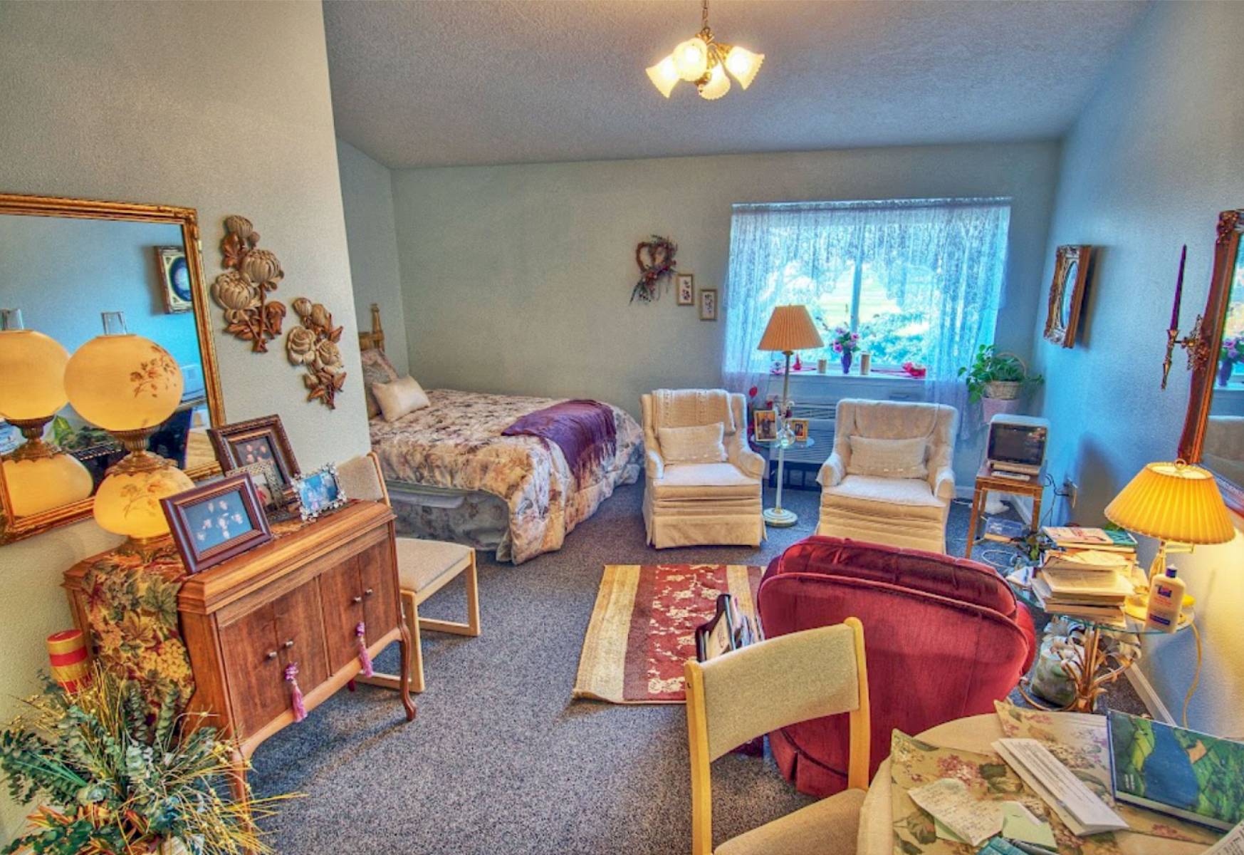 Cozy resident room with bed and chairs