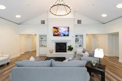 Bright interior common area with a fireplace and seating