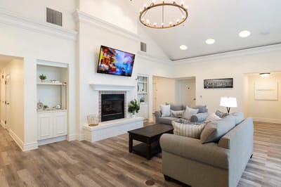 Bright common area with comfortable seating and a fireplace