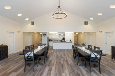 Bright dining room with large tables and modern decor
