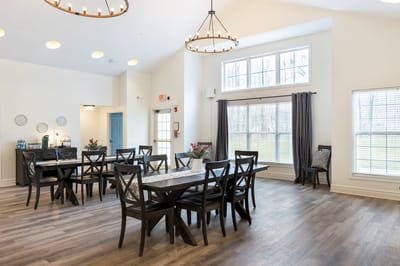 Bright dining room with large windows and wooden tables