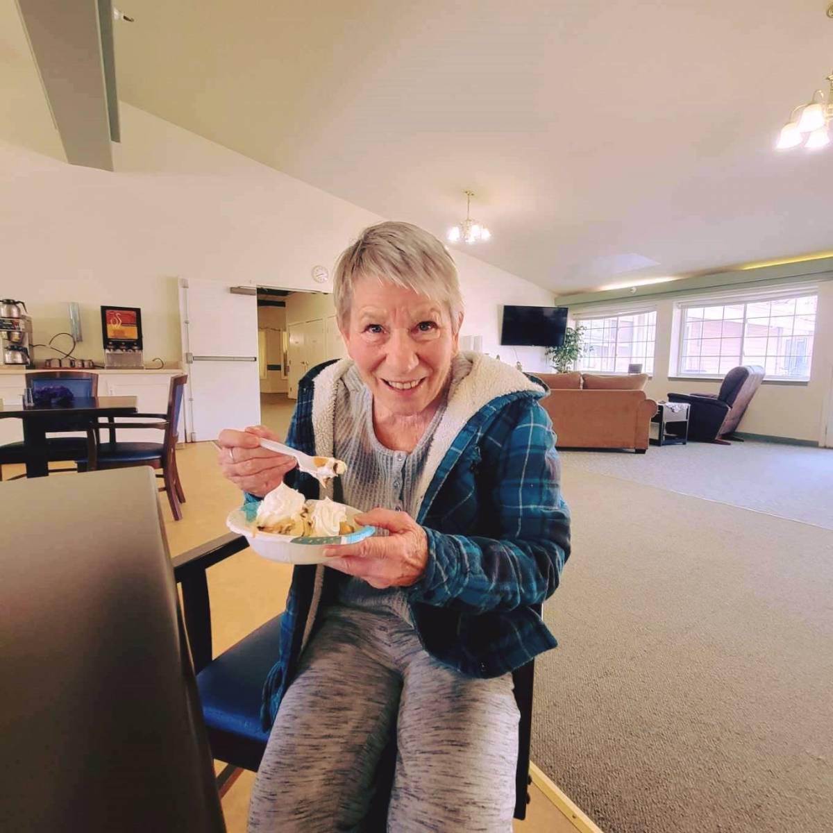 Resident enjoying dessert in a common area