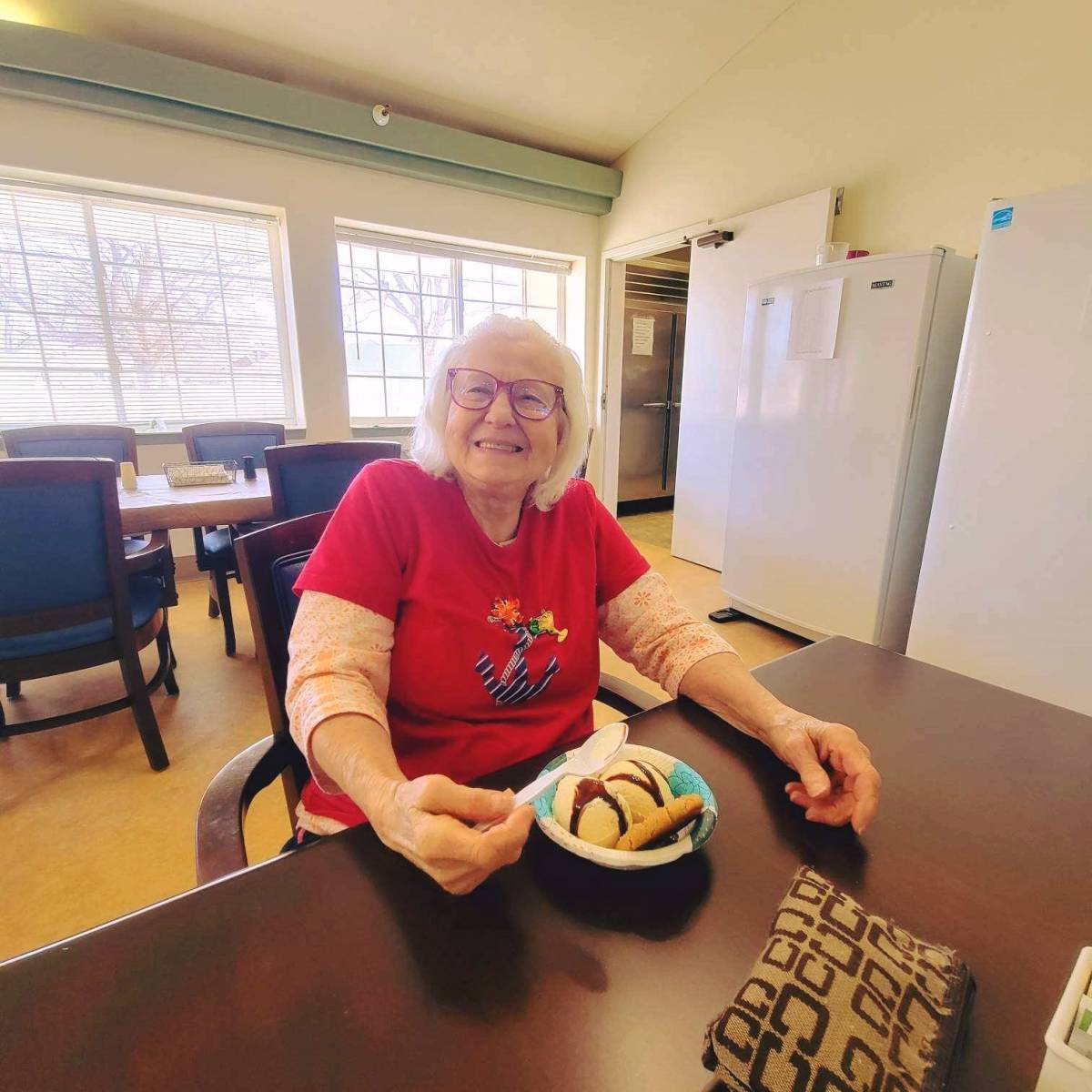 A resident enjoying dessert in a dining area