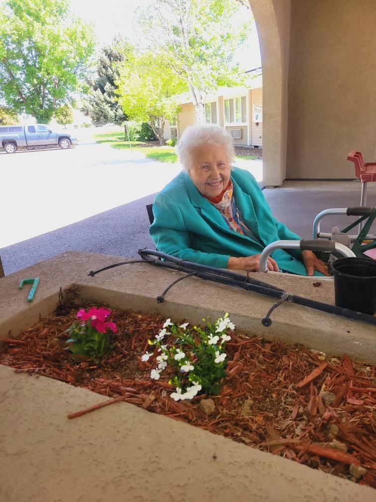 A smiling resident enjoying the garden area