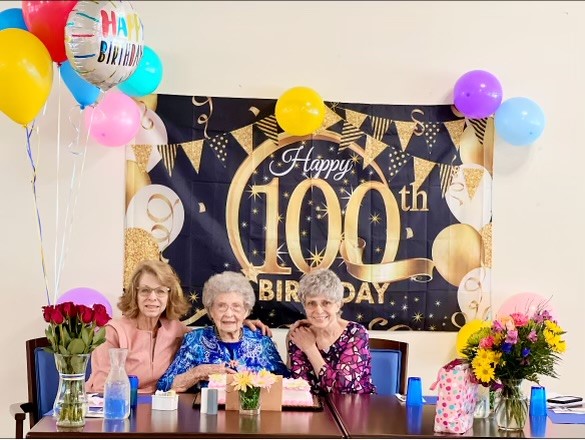 Residents celebrating a 100th birthday with family