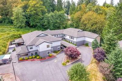Aerial view of The Amber Senior Living facility with gardens
