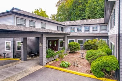 Entrance view of The Amber Senior Living facility with garden