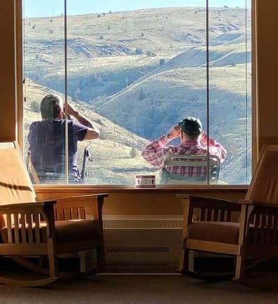 Two residents enjoying a scenic view from the common area
