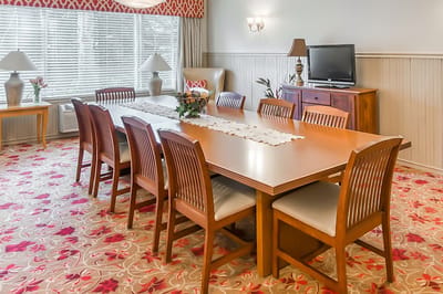 Dining room setup with wooden table and chairs