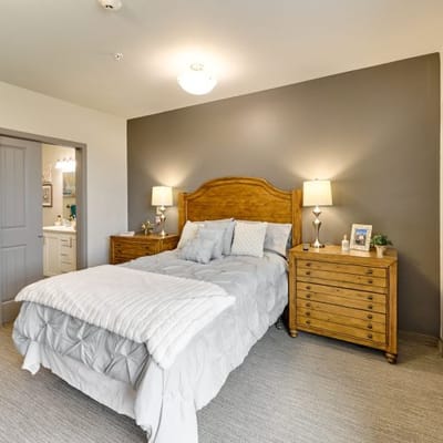 A well-furnished private resident room with a bed and decor