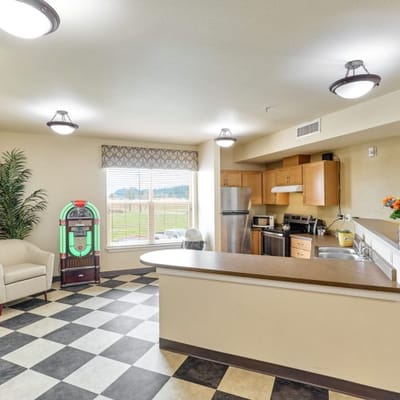 Bright interior kitchen and living area in assisted living facility