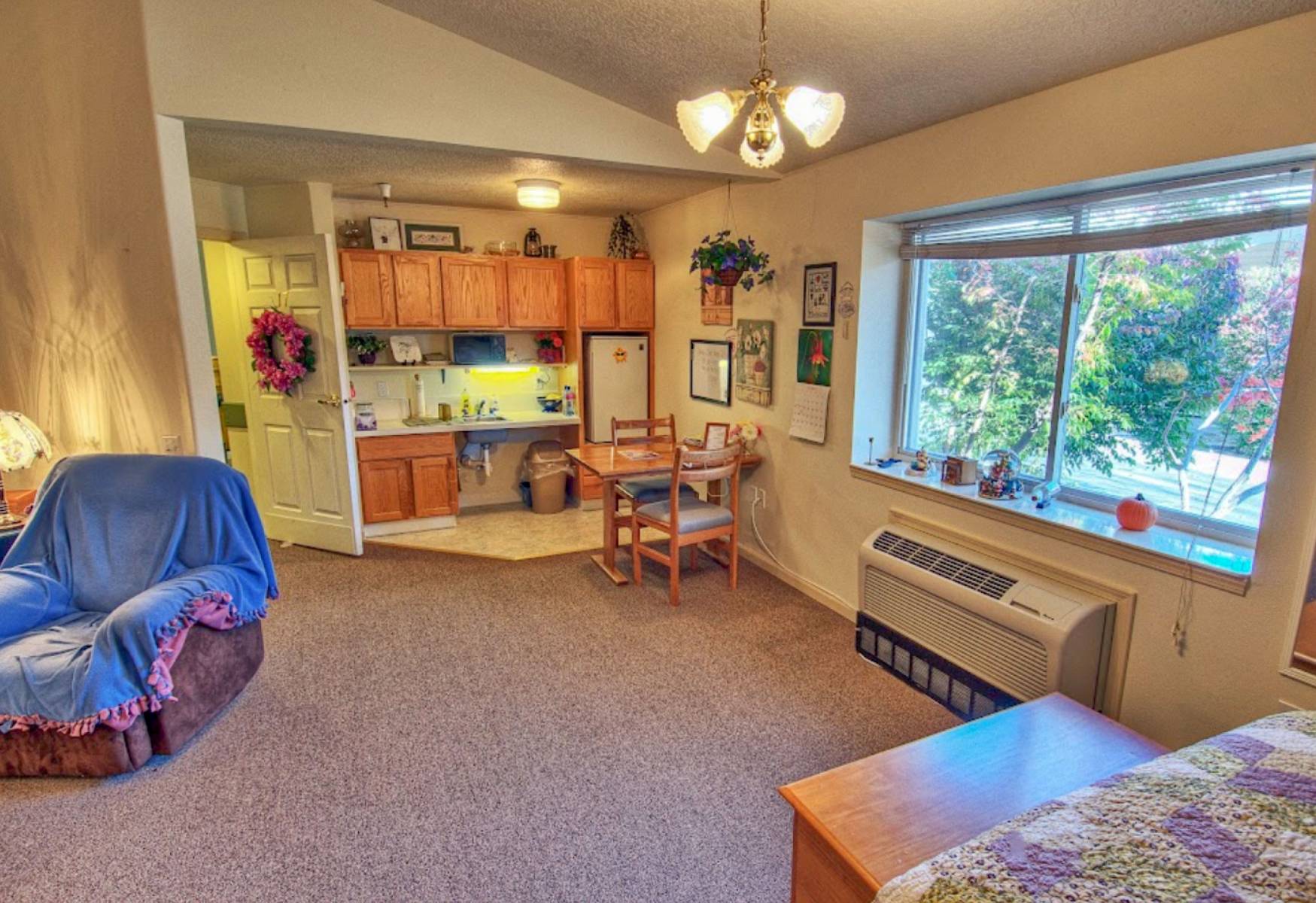 Cozy resident room with kitchenette and sitting area