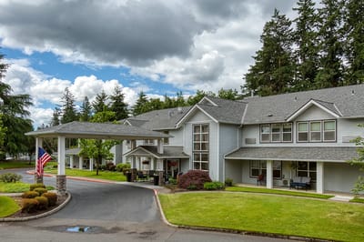 Exterior view of Homewood Assisted Living with gardens and entrance