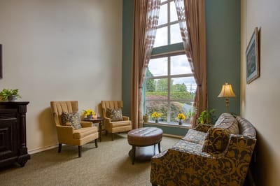 Bright common area with seating and large windows