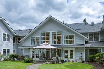 Exterior view of a senior living facility with patio