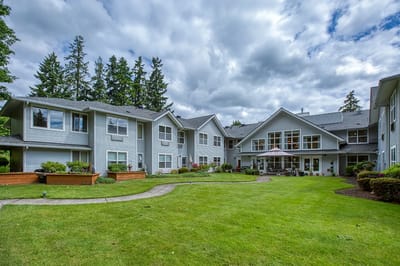 Exterior view of the assisted living facility with gardens