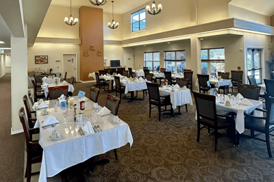 Dining room with elegantly set tables and chairs