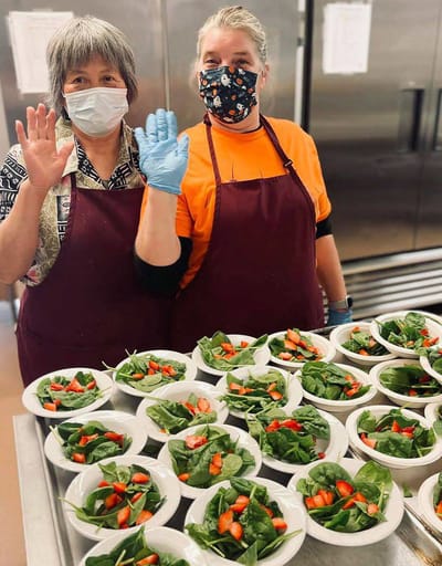 Staff preparing fresh salads in the kitchen