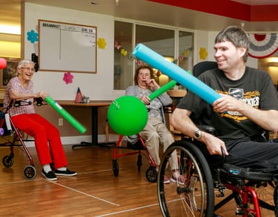 Residents participating in an activity with foam sticks