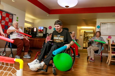 Residents participating in an engaging activity indoors