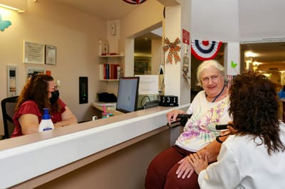 Residents interacting with staff at the reception area