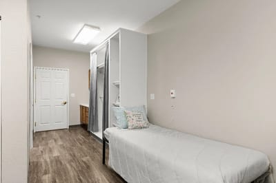 A private resident room with a bed and bathroom