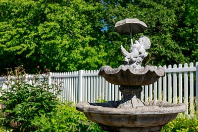Stone fountain in a garden with greenery