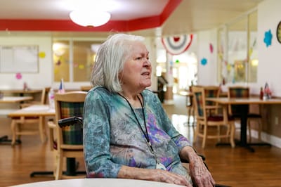 Resident enjoying time in a common area of the facility
