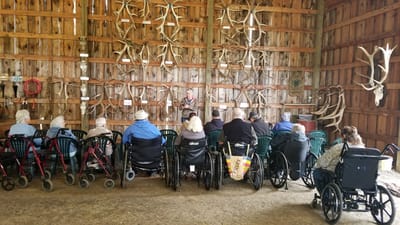 Residents attending a group activity in a rustic interior