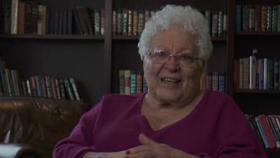 Resident smiling in a cozy reading area
