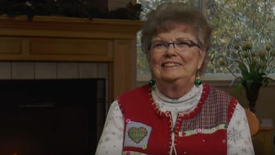 A smiling resident in a cozy indoor setting