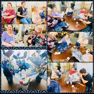 Residents participating in a festive group activity with crafts.
