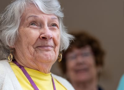 The Village at Lifequest, nursing home in Quakertown, PA — Smiling senior woman with bright expression in background