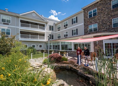 The Village at Lifequest, nursing home in Quakertown, PA — Senior residents enjoying a peaceful garden pond area