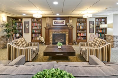 A cozy common area with bookshelves and seating