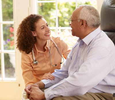 Spiritrust Lutheran – the Village at Sprenkle Drive, nursing home in York, PA — Healthcare professional interacting warmly with a senior resident